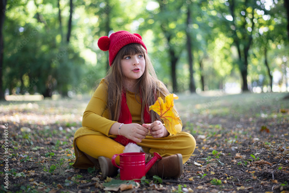 Obraz premium Little girl in autumn park, Child enjoying and playing