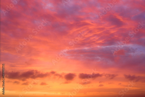 High angle shot of clouds lit by afternoon sun with orange and reds saturated © Andrew Atkinson