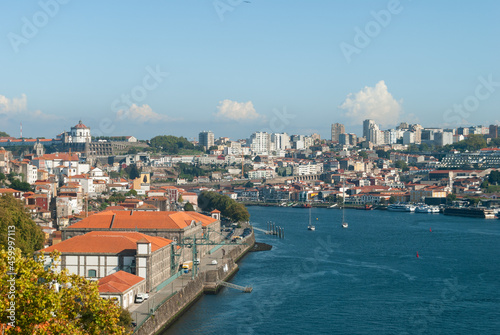 Landscape view of Porto, Gaia and river Douro on a sunny day with some yachts and boats passing by red-tiled roofs - Porto, Portugal