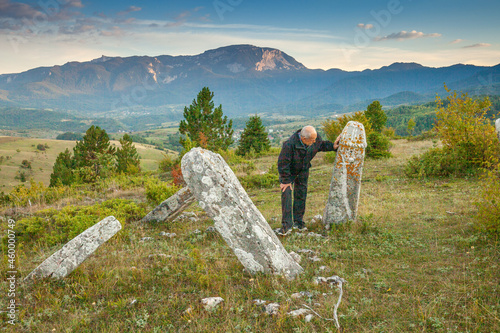 Old man and mystical stone on Bjelasnica, in Bosnia and Herzegovina, photo