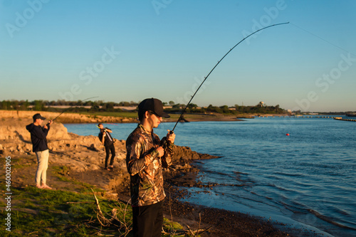 Friends gathered on the shore of the river to fish.