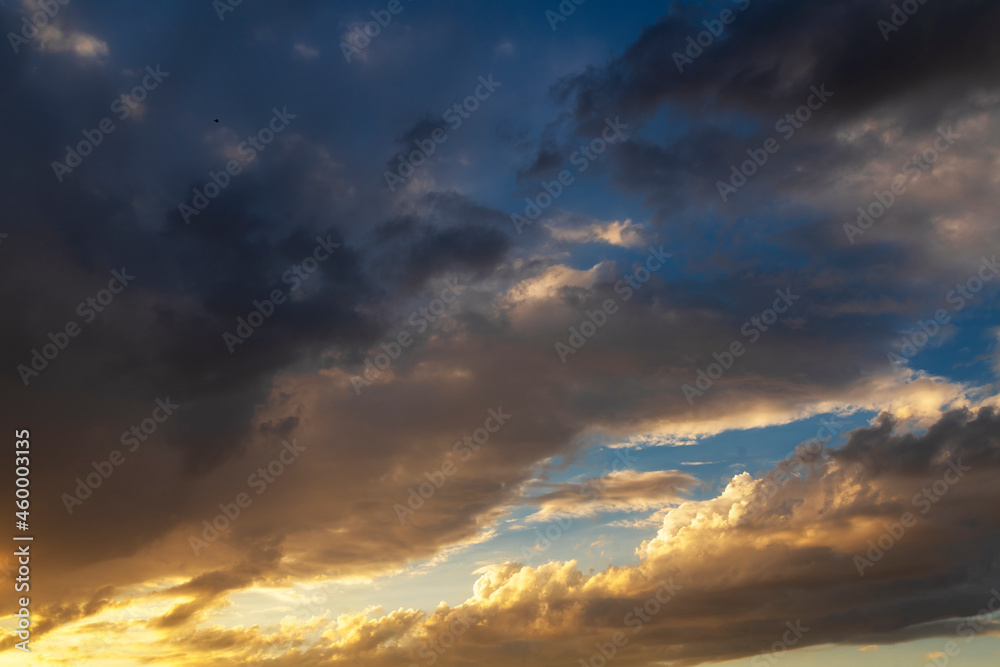 Beautiful bright sunset sky with clouds. Sky background.