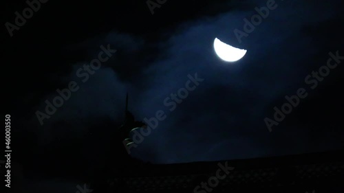 Japanese old castle and half moon. Waning moon. Moving cloud
