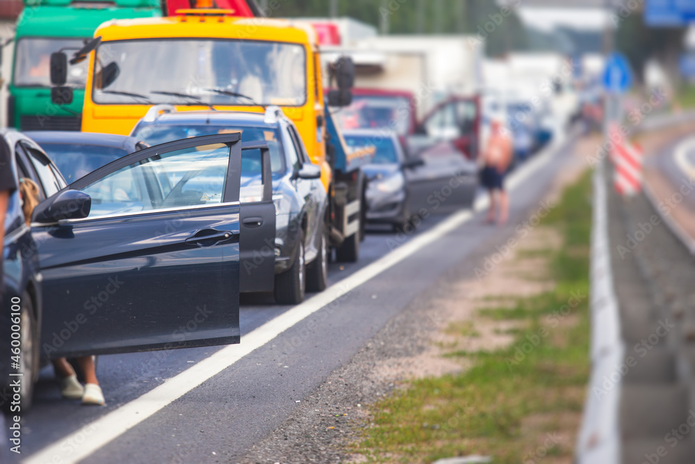 Massive traffic jam congestion on a multiple lane highway, road closure during road repair works maintenance, drivers outside their cars and trucks, road temporary closed