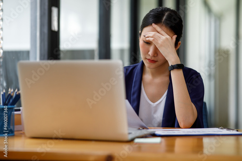 Tired Asian woman, stress woman-Asian young businesswoman with a headache at office, feeling sick at work, copy space photo