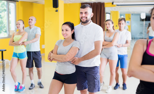 Positive adults dancing salsa together in modern dance studio