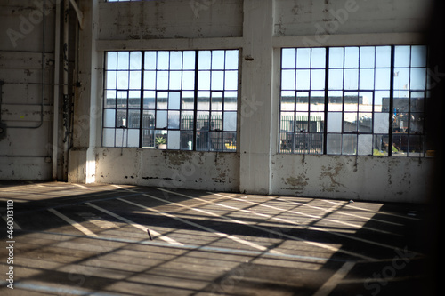 Old abandoned building interior pier filled with sun light reflection through windows