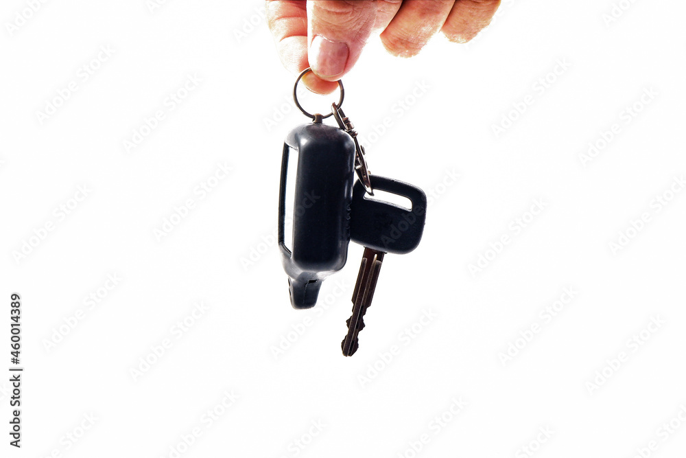 in his hand hangs a keychain with keys and an alarm panel for the car in his hand hangs a keychain with keys and an alarm panel for the car