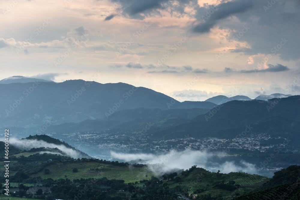 Dramatic image of stormy skies high in the Caribbean mountains of the Dominican Republic with low fog in the valley. Dramatic image of stormy skies high in the Caribbean mountains of the Dominican Republic with low fog in the valley.