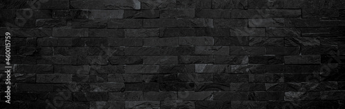 Panorama of black stone wall texture backgrounds for design.