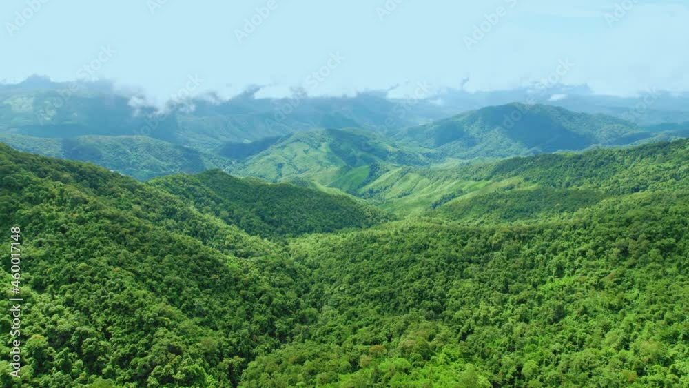 Aerial view drone shot of flowing fog waves on mountain tropical rainforest In the evening,Bird eye view image over the clouds Amazing nature background with clouds and mountain peaks. Aerial view drone shot of flowing fog waves on mountain tropical rainforest In the evening,Bird eye view image over the clouds Amazing nature background with clouds and mountain peaks.
