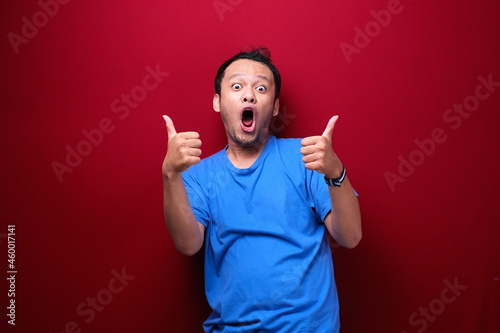 Fényképezés Wow and shocked face of Young Asian man with open hand gesture