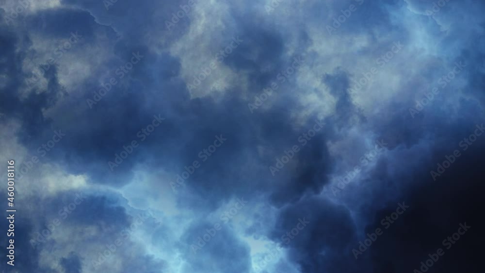 a thunderstorm, a flash of lightning flashing across a dark sky with moving clouds a thunderstorm, a flash of lightning flashing across a dark sky with moving clouds
