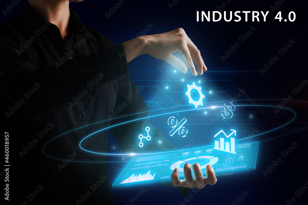 Naklejka premium Business, Technology, Internet and network concept. Young businessman working on a virtual screen of the future and sees the inscription: Industry 4.0