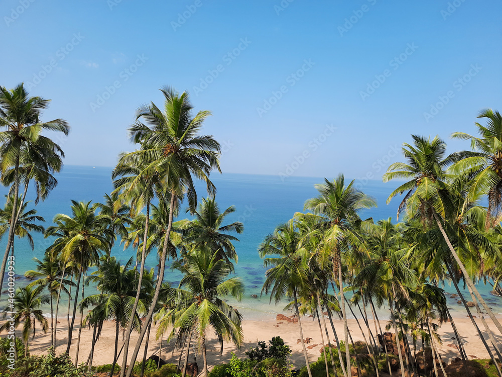  turquoise ocean against blue sky with clouds on sunny summer day. Background for travel and vacation. goa beach. 