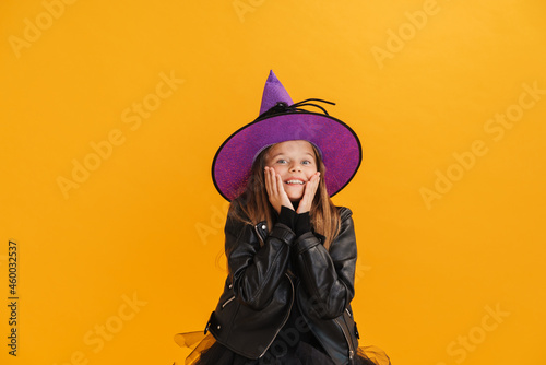 White girl wearing witch costume smiling and looking at camera