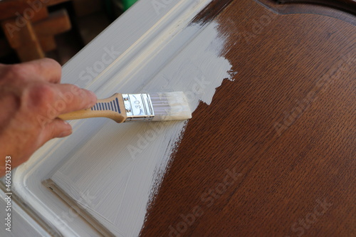 Fototapeta Naklejka Na Ścianę i Meble -  a brown kitchen cabinet is painted with white chalk paint