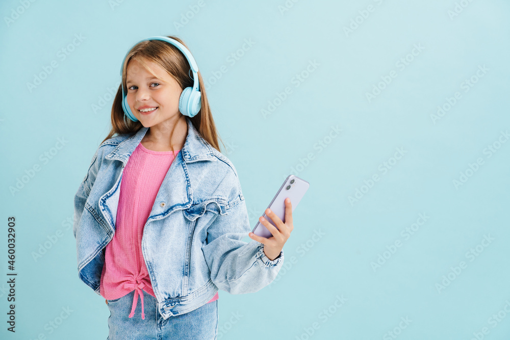 White girl dressed denim jacket listening music and using cellphone