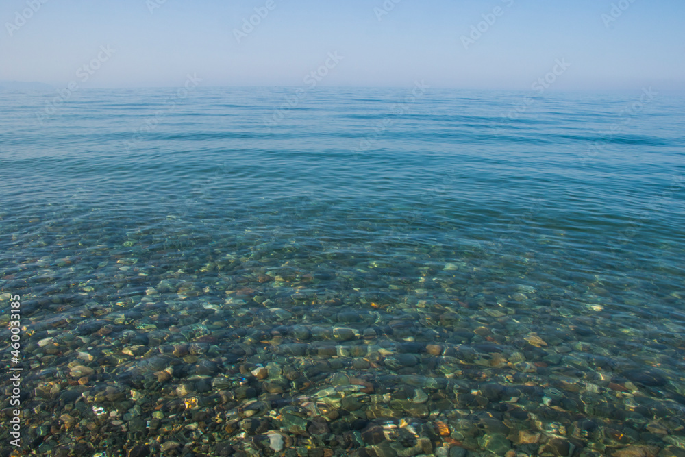 Stones in clear water of sea, water background