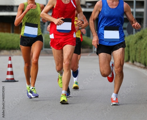 runners run during the foot race is in the city with muscular legs