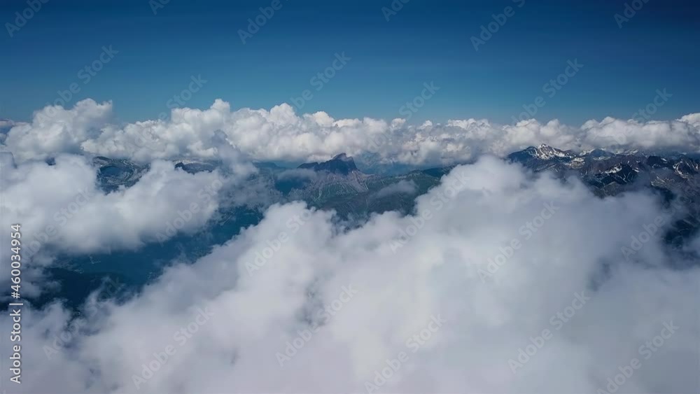 Aerial flight through clouds over mountain landscape Aerial flight through clouds over mountain landscape