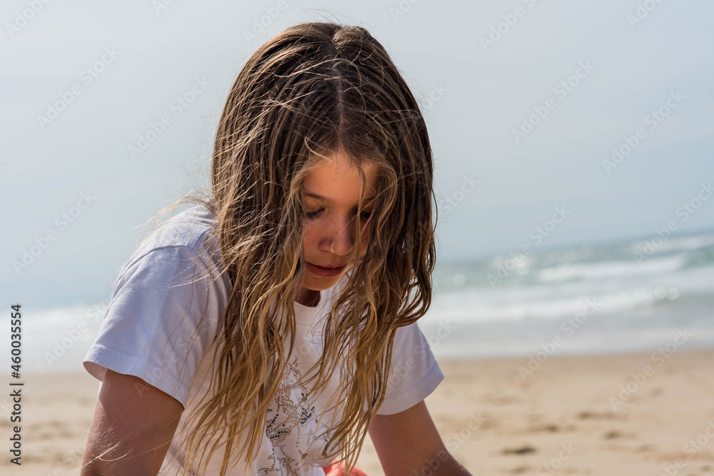 portrait of a pretty little girl making sand blocks on a sunny beach portrait of a pretty little girl making sand blocks on a sunny beach