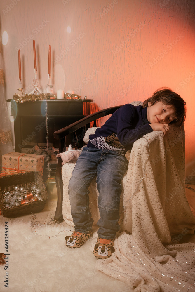 Christmas Child , Happy Boy dreeming, Kid sitting front of Xmas Tree Christmas Child , Happy Boy dreeming, Kid sitting front of Xmas Tree