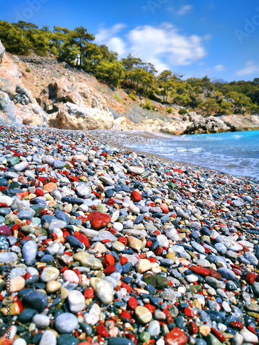 A pebble beach with colored round pebbles near the Mediterranean sea