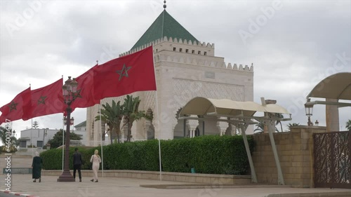 Camera capturing the red flags fluttering in front of Darih Rabat in Morocco; religious tourist spot in Morocco. photo