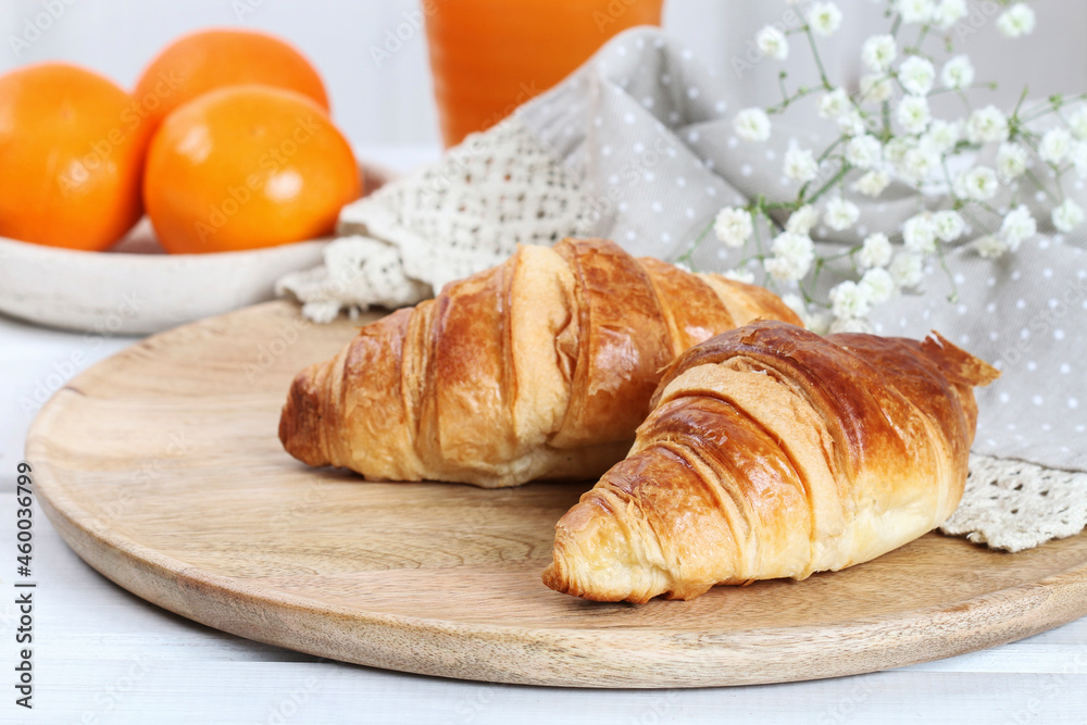French croissants and mandarines on the table French croissants and mandarines on the table