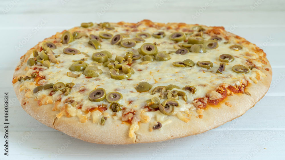 Pizza with green olives and mozzarella cheese on white wooden background.