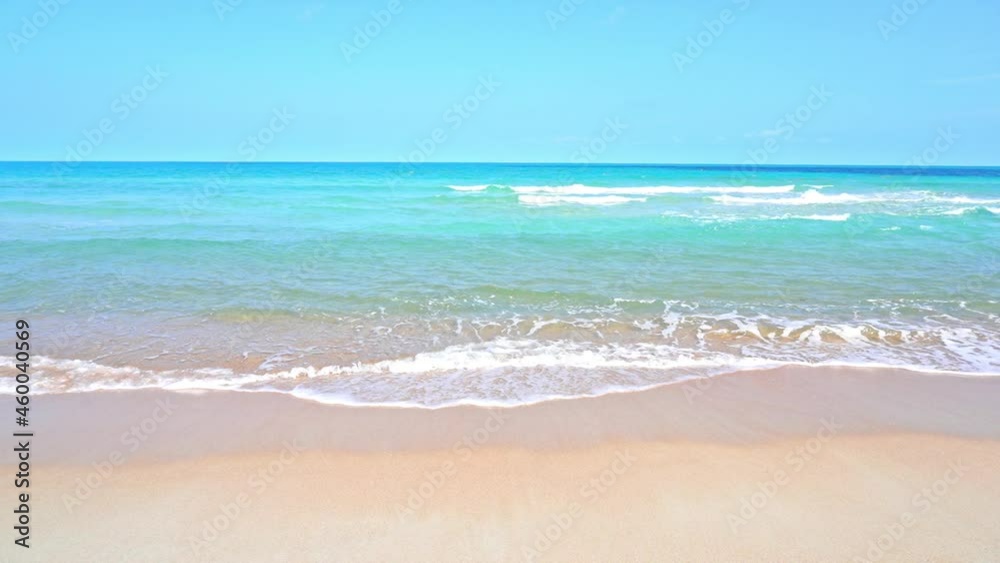 Foamy turquoise waves rolling over white sand beach in Thailand on idyllic sunny day Foamy turquoise waves rolling over white sand beach in Thailand on idyllic sunny day