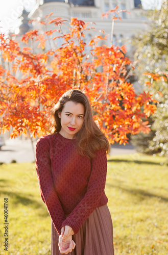 beautiful woman in burgundy sweater in autumn park 