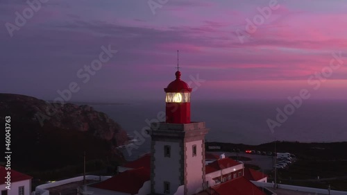 The Cabo da Roca Lighthouse, Sintra, Portugal, Europe. Aerial view of breathtaking natural scenery with operating beacon. Steep cliffs under the purple skies as seen from top. High quality 4k footage