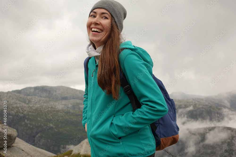 Naklejka premium female hiker in the mountains smiling 