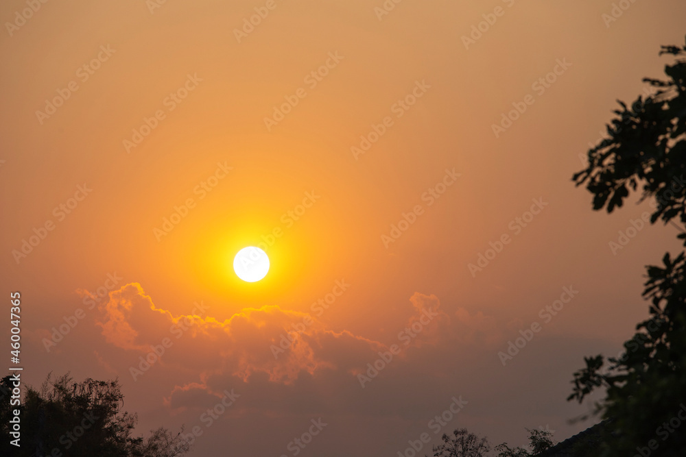 Sunset sky clouds background. Beautiful landscape with clouds and orange sun on sky.