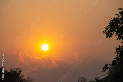 Sunset sky clouds background. Beautiful landscape with clouds and orange sun on sky.