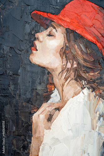 Fototapeta Naklejka Na Ścianę i Meble -  Attractive young woman with red lips and red hat on a dark background. Palette knife technique of oil painting and brush.
