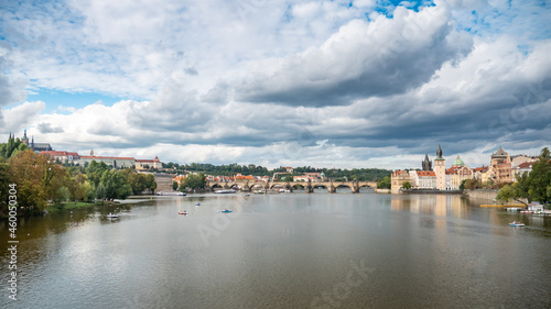 Prague, Czech Republic. A view over the Vlatava River with the Charles Bridge leading towards the landmarks of Prague Castle and St. Vitus Cathedral.