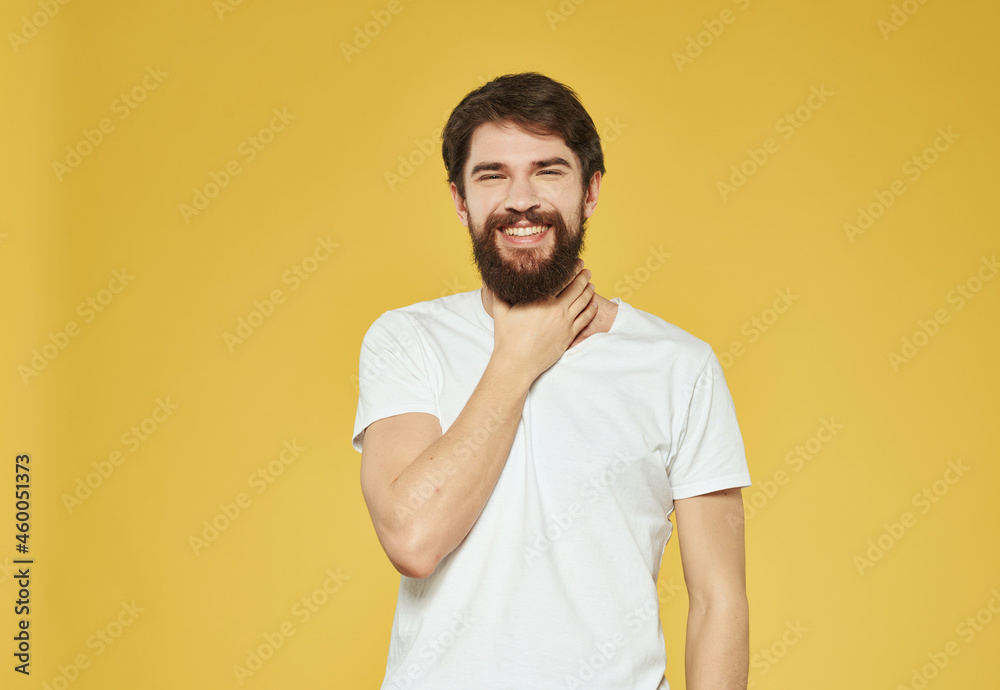 bearded man in a white t-shirt expressive look discontent close-up