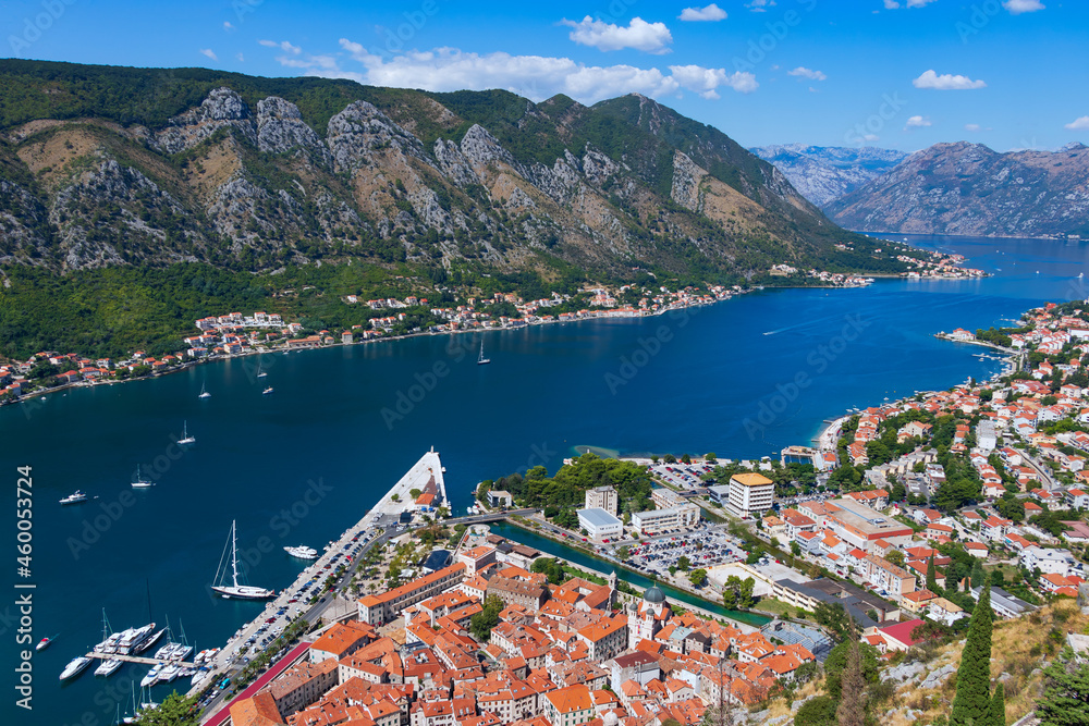 A picturesque panoramic view from the observation deck of the Fortress of St. John to the red roofs of old houses the towns of Kotor, the Bay of Kotor and the marina