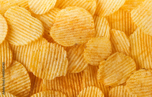 Screen filling ribbed potato chips or crisps background 