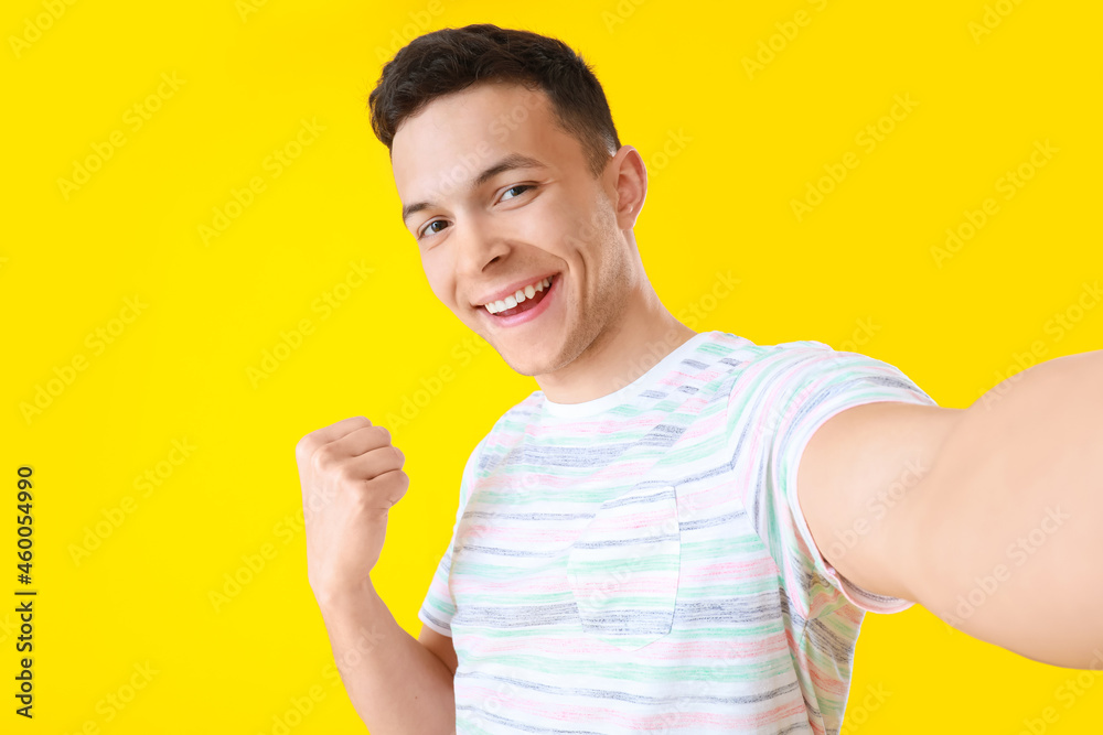 Young man taking selfie on color background Young man taking selfie on color background