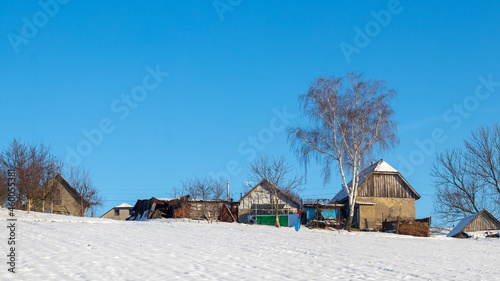 Old village houses in winter on a sunny day