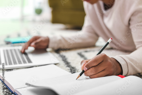African-American student preparing for exam at home, closeup