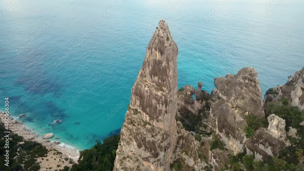 Aerial drone video of coastline and beach of Cala Goloritzé with impressive rock formation at the turquoise water of the mediterranean sea during sunset, Italy Aerial drone video of coastline and beach of Cala Goloritzé with impressive rock formation at the turquoise water of the mediterranean sea during sunset, Italy