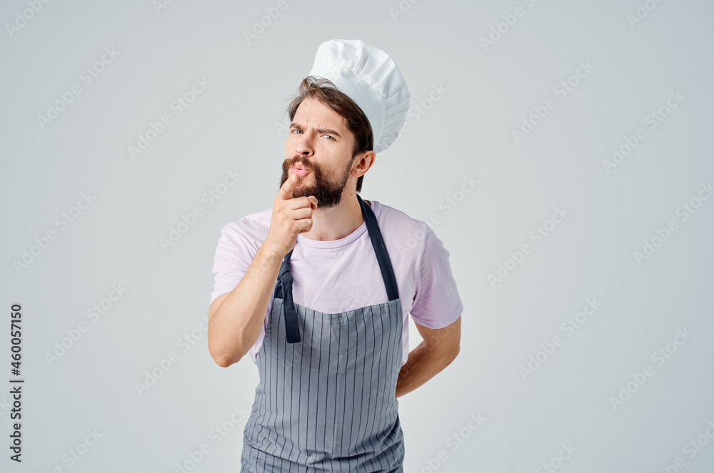 a man in a chef's uniform emotions of a professional work in the kitchen a man in a chef's uniform emotions of a professional work in the kitchen