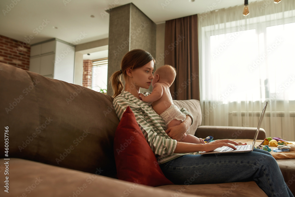 Woman trying to combine remote work and childcare Woman trying to combine remote work and childcare