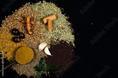 Various spices, turmeric, ginger, cumin seeds, cinnamon and herbs close-up top view. Eastern spice market. A set of peppers and spices for cooking.