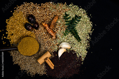 Various spices, turmeric, ginger, cumin seeds, cinnamon and herbs close-up top view. Eastern spice market. A set of peppers and spices for cooking.